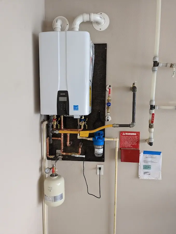 Professional plumber installing copper piping in a Saks home